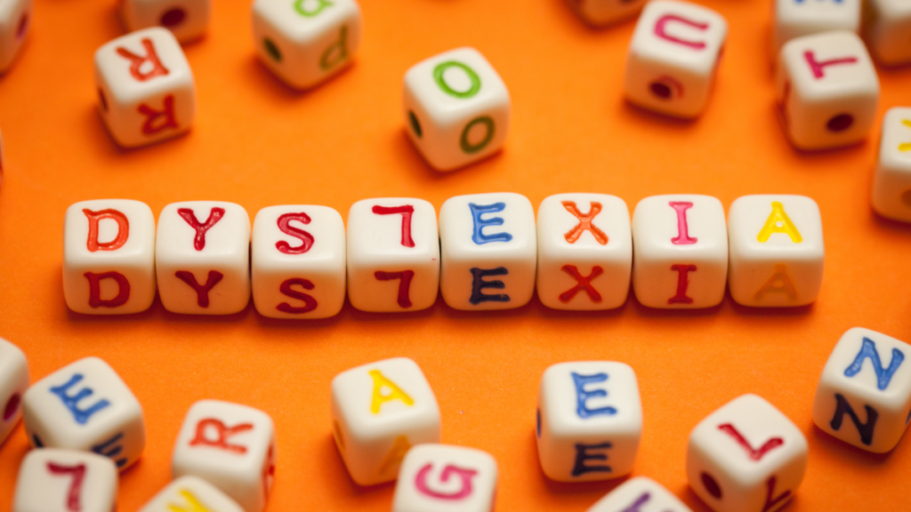 Dyslexia written with letter dice, with an "l" backwards.