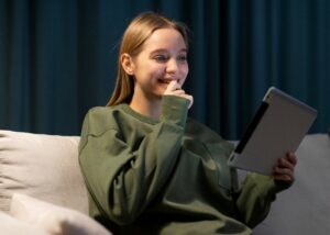 Girl Reading On Her Tablet