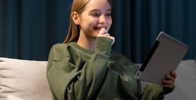 Girl Reading On Her Tablet